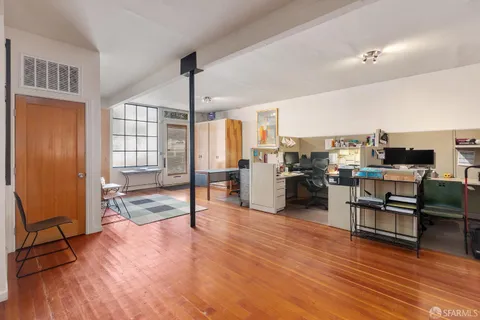 a living room with furniture and kitchen view