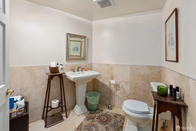 a bathroom with a sink toilet and a mirror