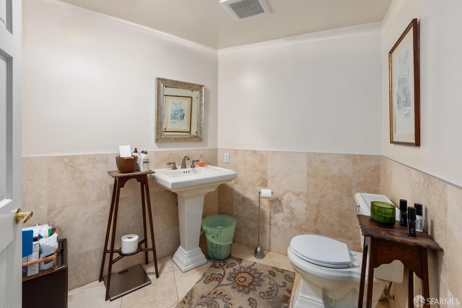 67-71 Haight Street San Francisco, CA 94102 - Photo 23 of 25 a bathroom with a sink toilet and a mirror