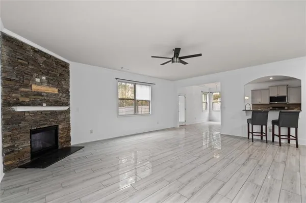 a view of empty room with wooden floor and fireplace