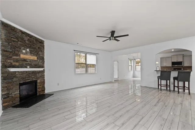 a view of empty room with wooden floor and fireplace