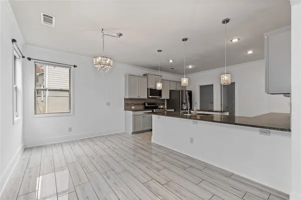 a large kitchen with stainless steel appliances granite countertop a large counter top and a stove