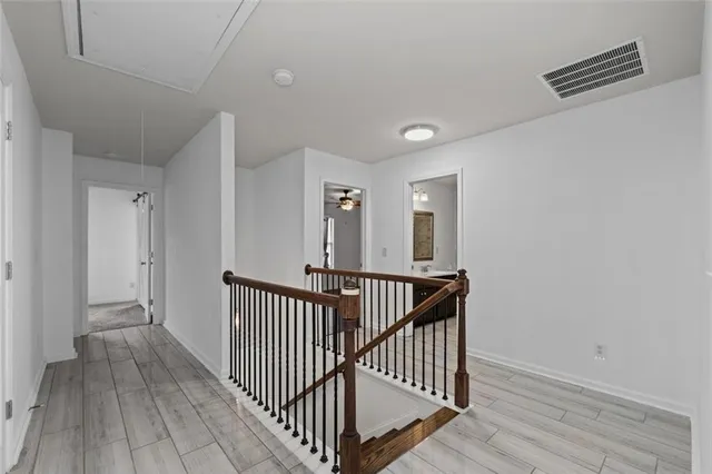 a view of a hallway view with wooden floor and staircase