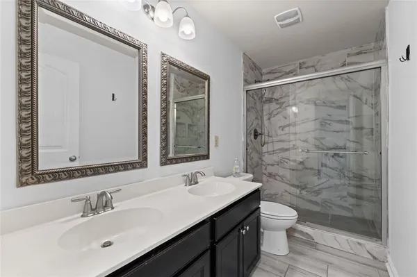 a bathroom with a sink mirror toilet and shower