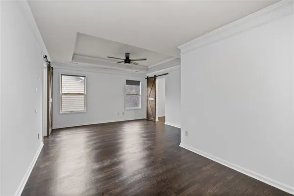 a view of a livingroom with wooden floor and a window