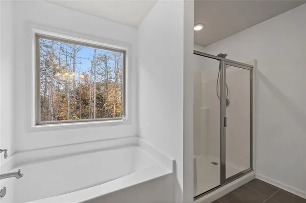 a white bath tub sitting next to a shower