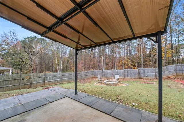 a view of a room with wooden floor and fence