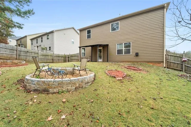 a swimming pool with yard and outdoor seating