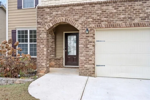 a front view of a house with plants