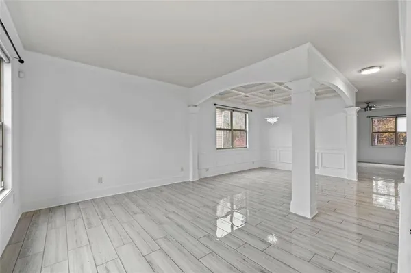 a view of empty room with wooden floor