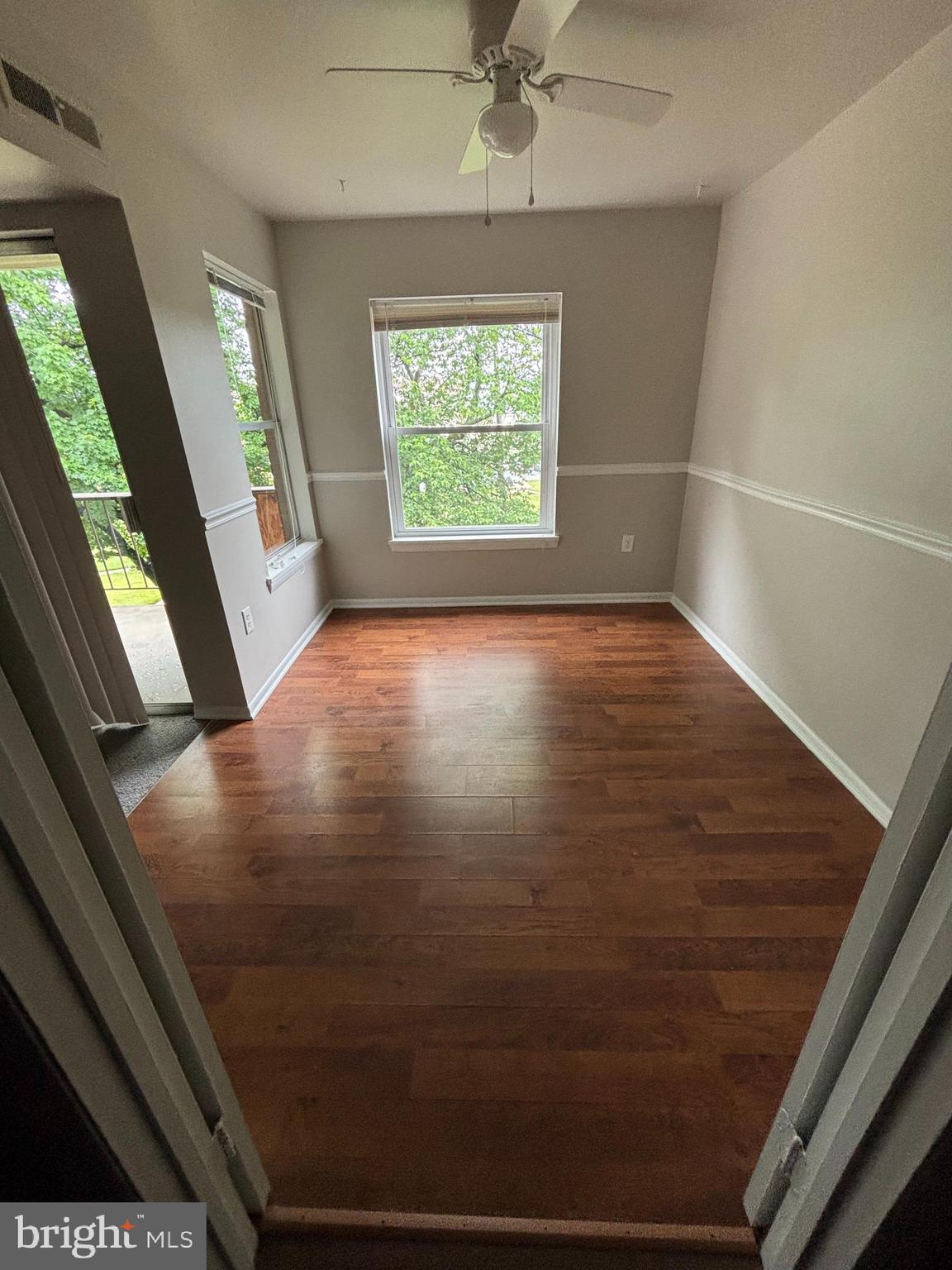 3853 St Barnabas Road, Unit 202 Suitland, MD 20746 - Photo 5 of 20 a view of empty room with wooden floor and fan