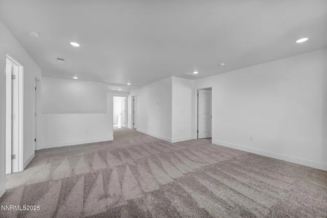 an empty room with windows and ceiling fan view