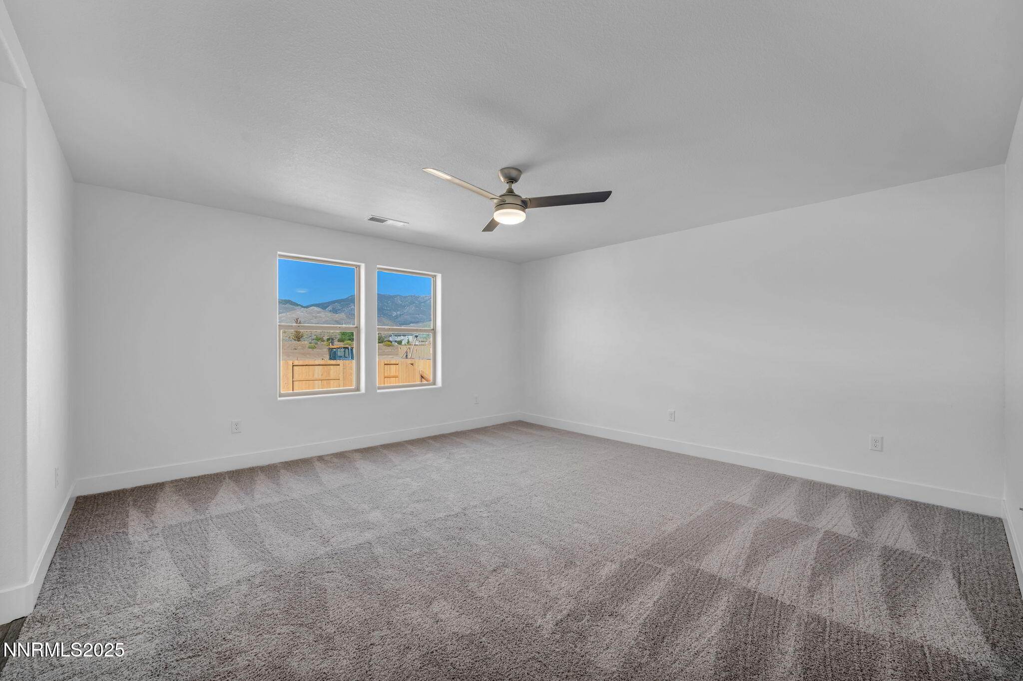1322 Nebula Road, Unit HOMESITE 92 Carson City, NV 89705 - Photo 12 of 22 an empty room with windows and ceiling fan view