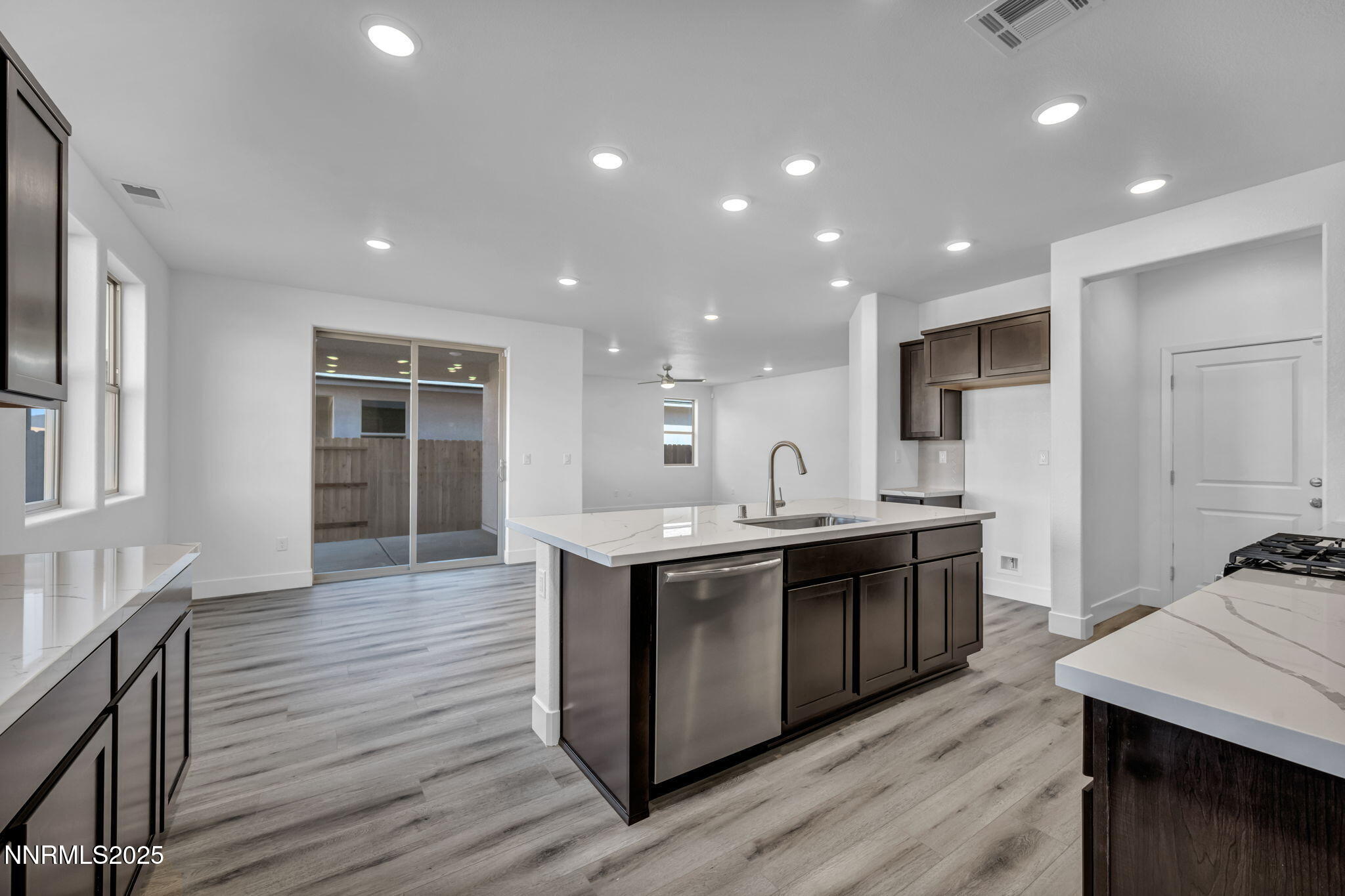 1322 Nebula Road, Unit HOMESITE 92 Carson City, NV 89705 - Photo 4 of 22 a large kitchen with stainless steel appliances a sink and wooden floor
