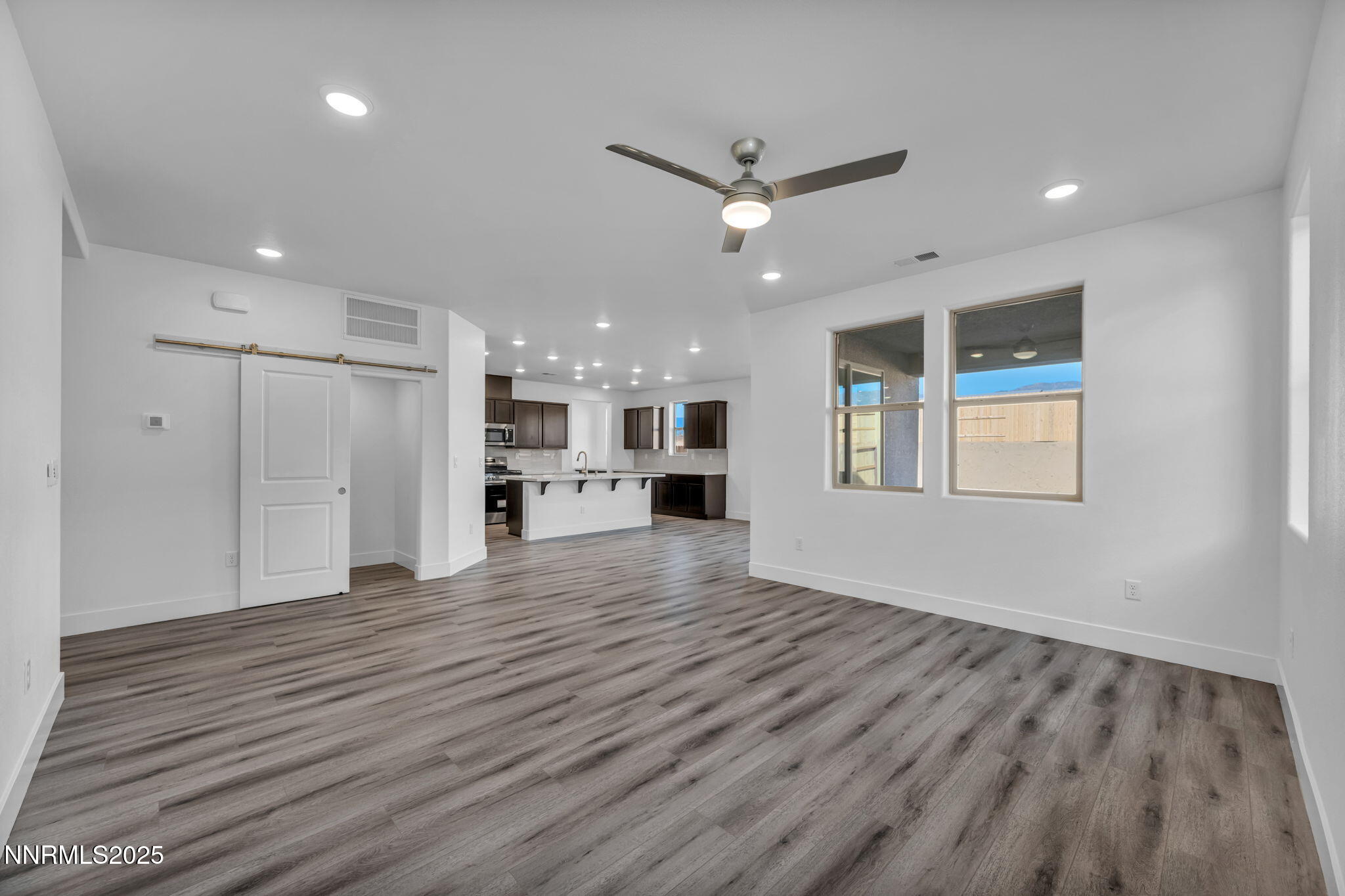 1322 Nebula Road, Unit HOMESITE 92 Carson City, NV 89705 - Photo 6 of 22 a view of an empty room with a window and wooden floor