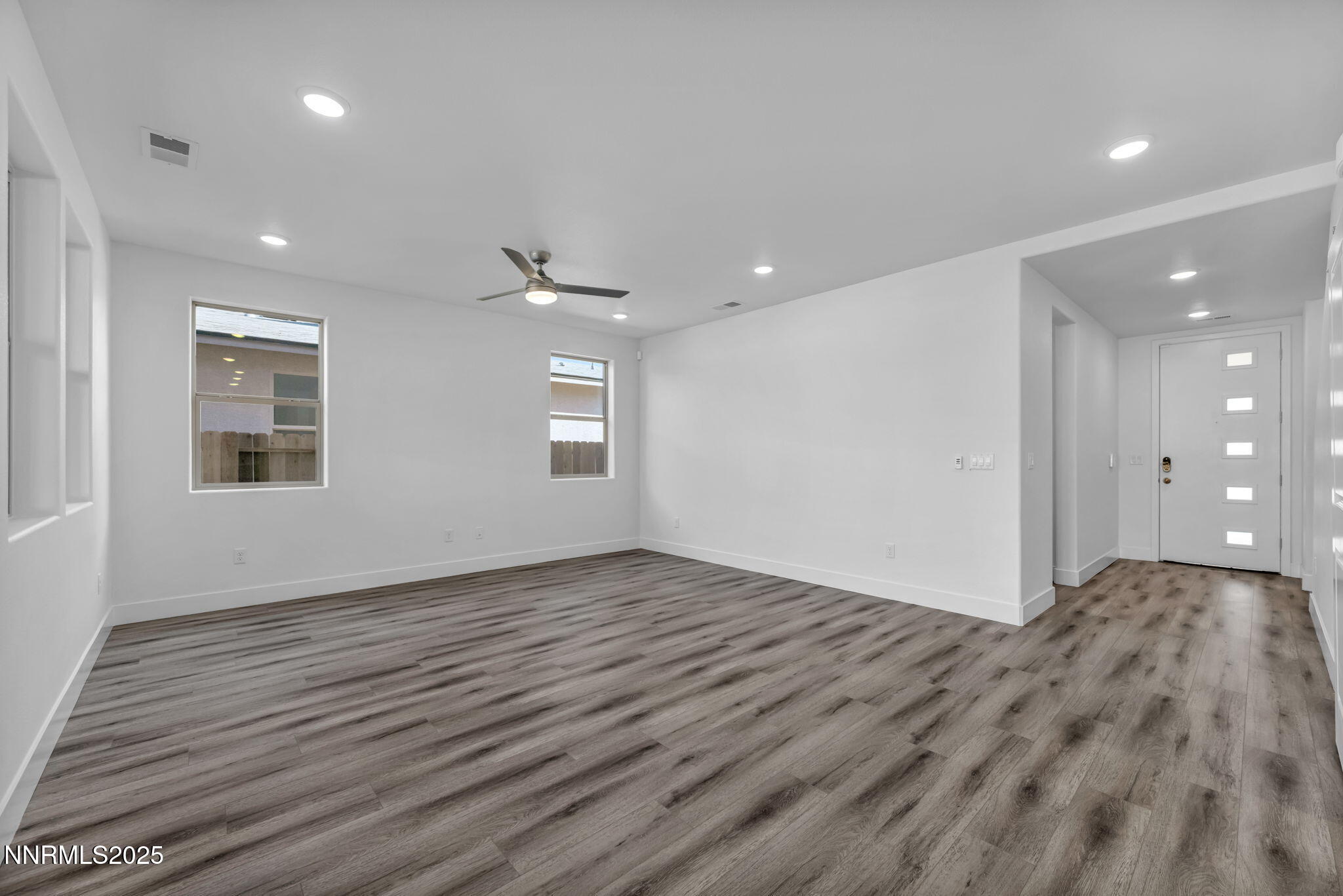 1322 Nebula Road, Unit HOMESITE 92 Carson City, NV 89705 - Photo 7 of 22 an empty room with wooden floor and windows