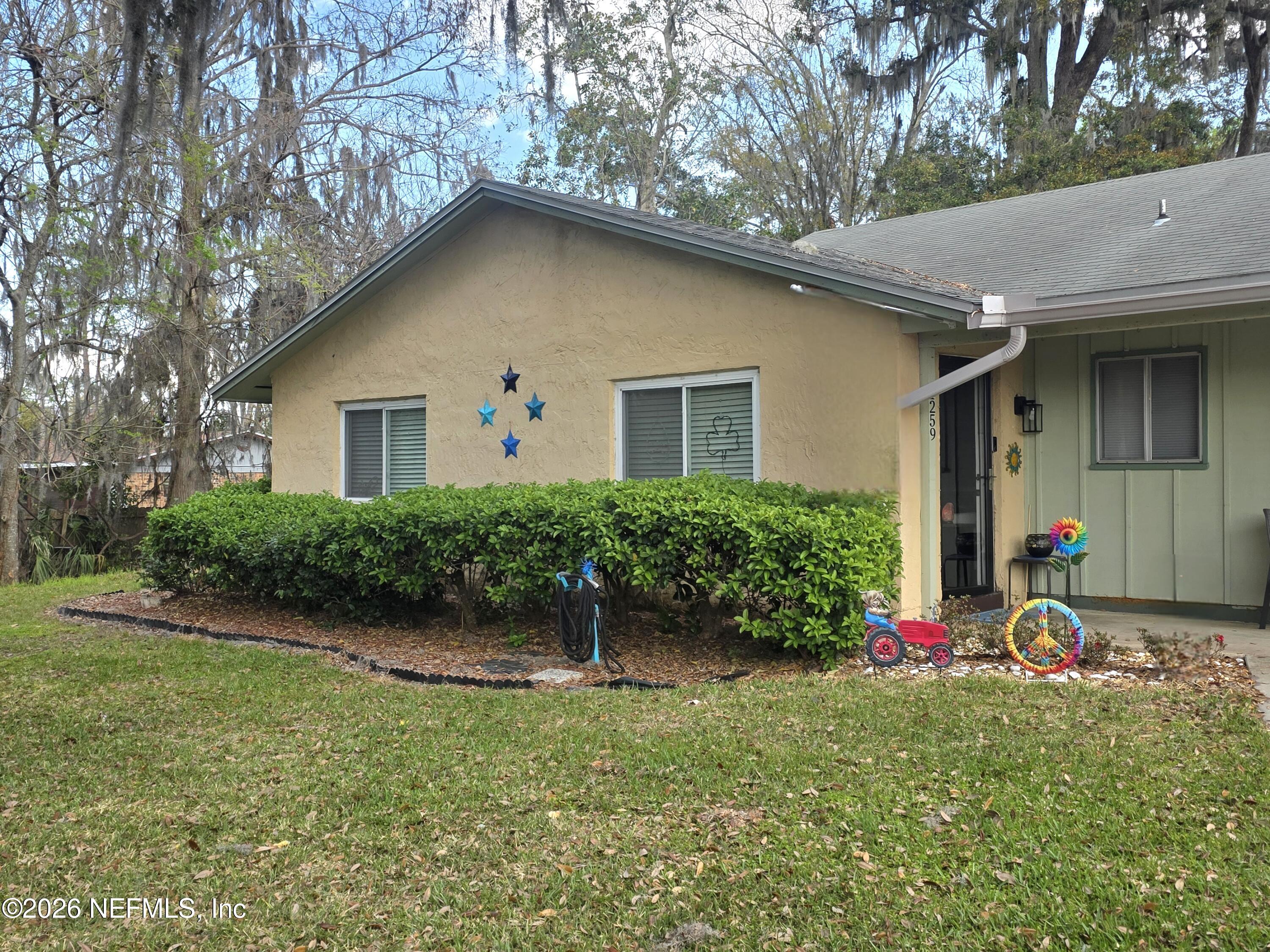 1259 The Grove Road Orange Park, FL 32073 - Photo 1 of 19 a front view of a house with a yard and garage