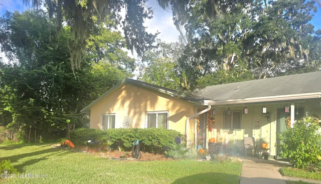 a view of house with yard