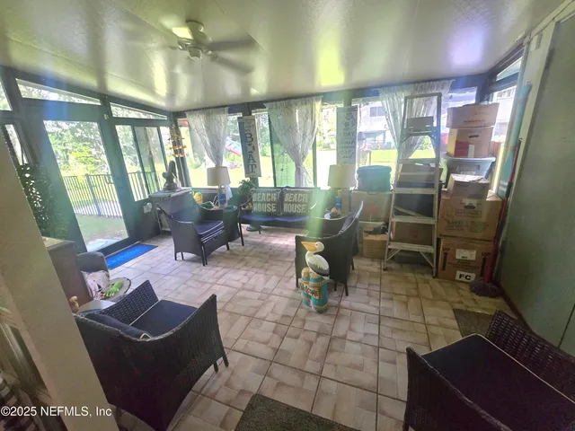 a living room with furniture and a floor to ceiling window