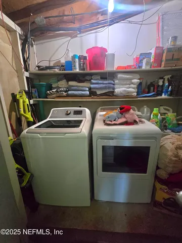 a utility room with stainless steel appliances and cabinets