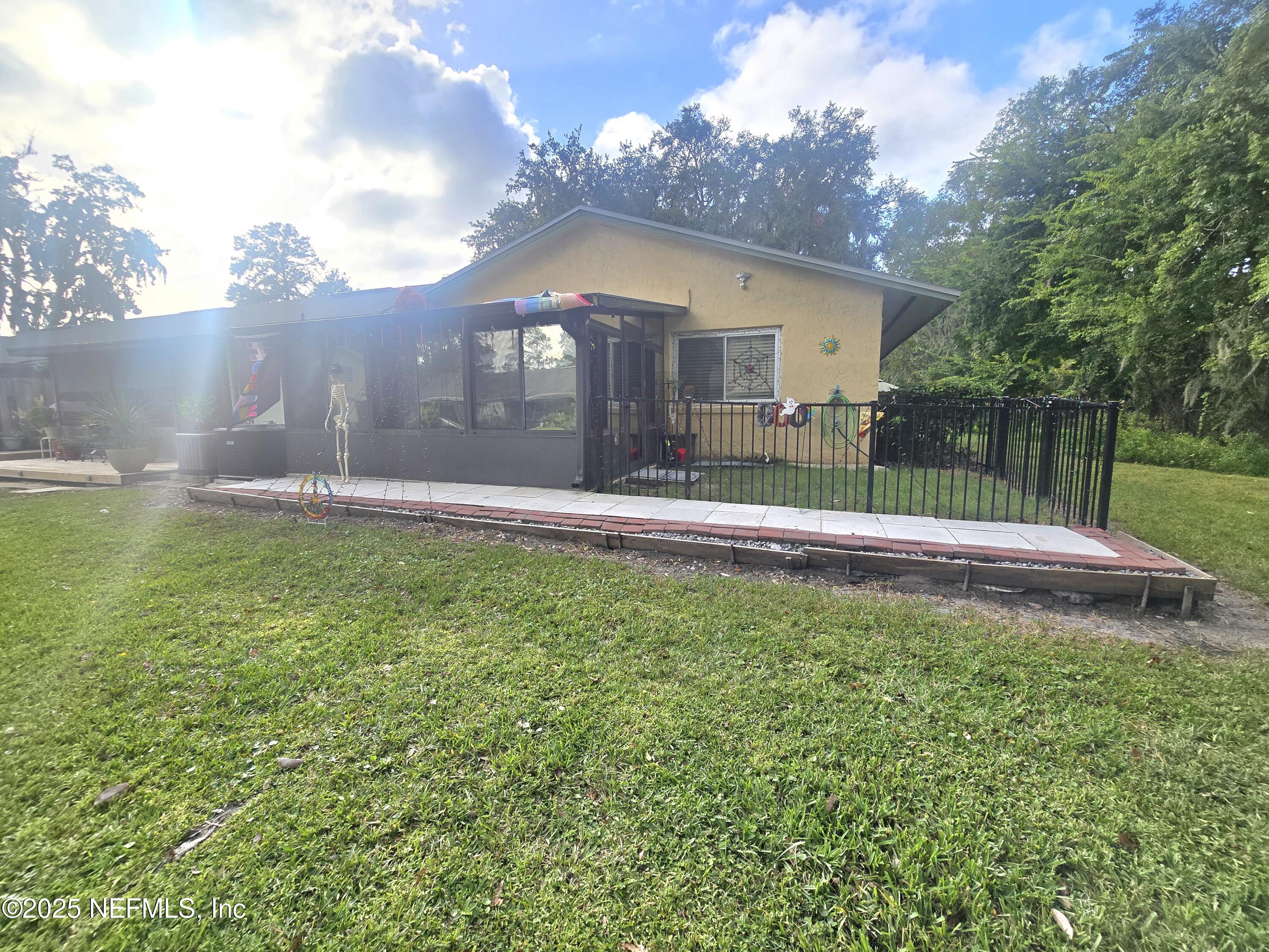 1259 The Grove Road Orange Park, FL 32073 - Photo 14 of 17 a view of a house with a yard and sitting area