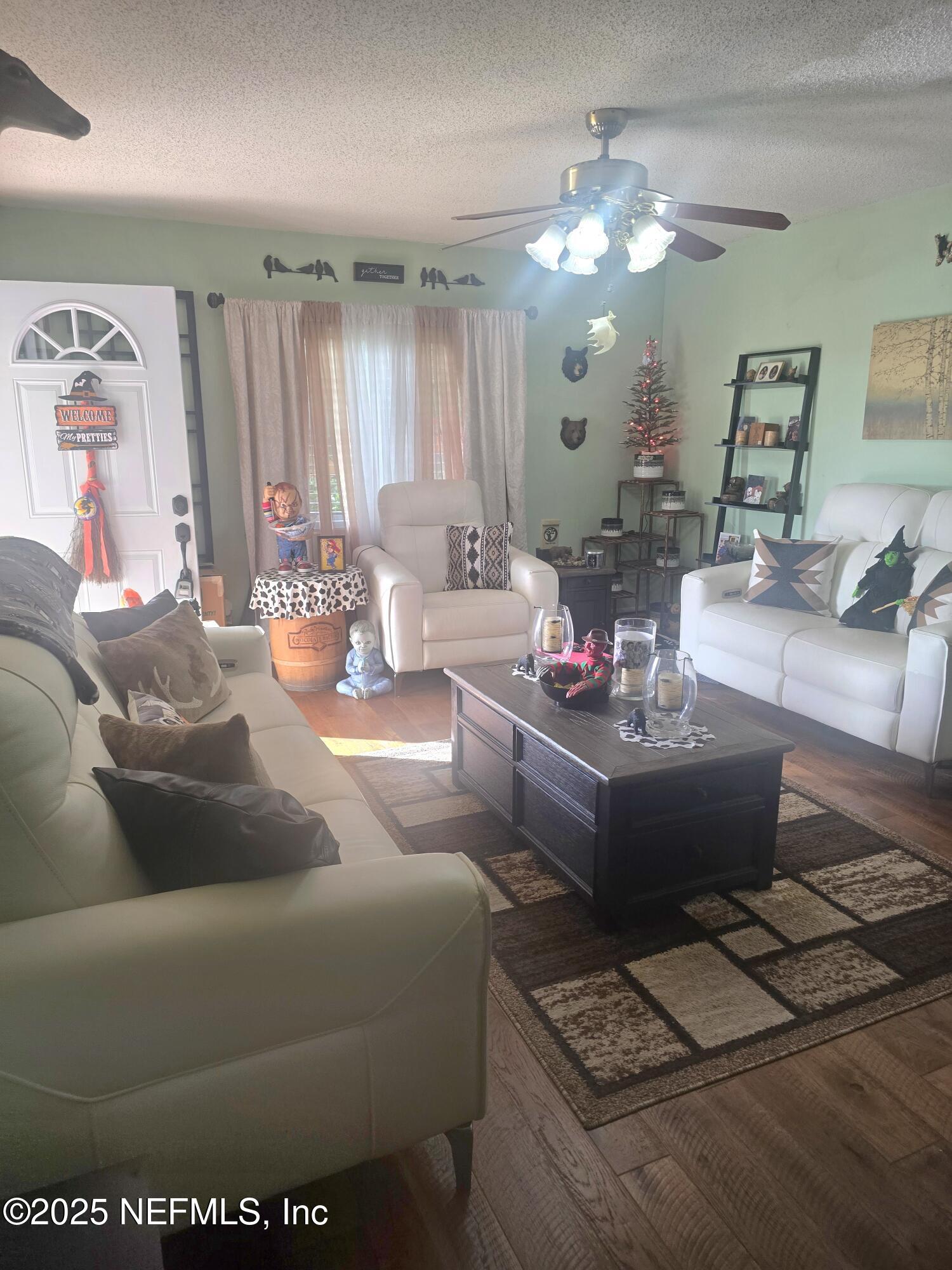 1259 The Grove Road Orange Park, FL 32073 - Photo 2 of 17 a living room with furniture and a large mirror