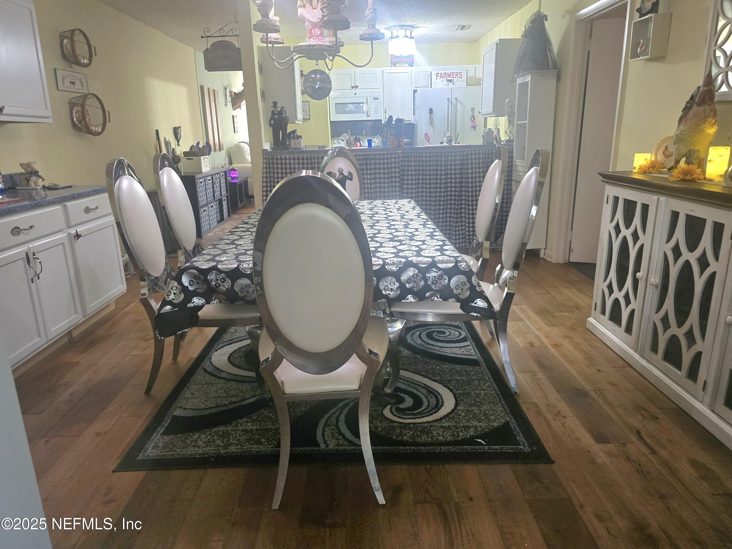 1259 The Grove Road Orange Park, FL 32073 - Photo 3 of 17 a dining room with furniture a rug and wooden floor