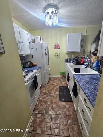 a kitchen with a stove and a refrigerator
