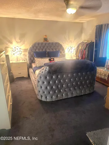 a bed sitting in a bedroom next to a lamp