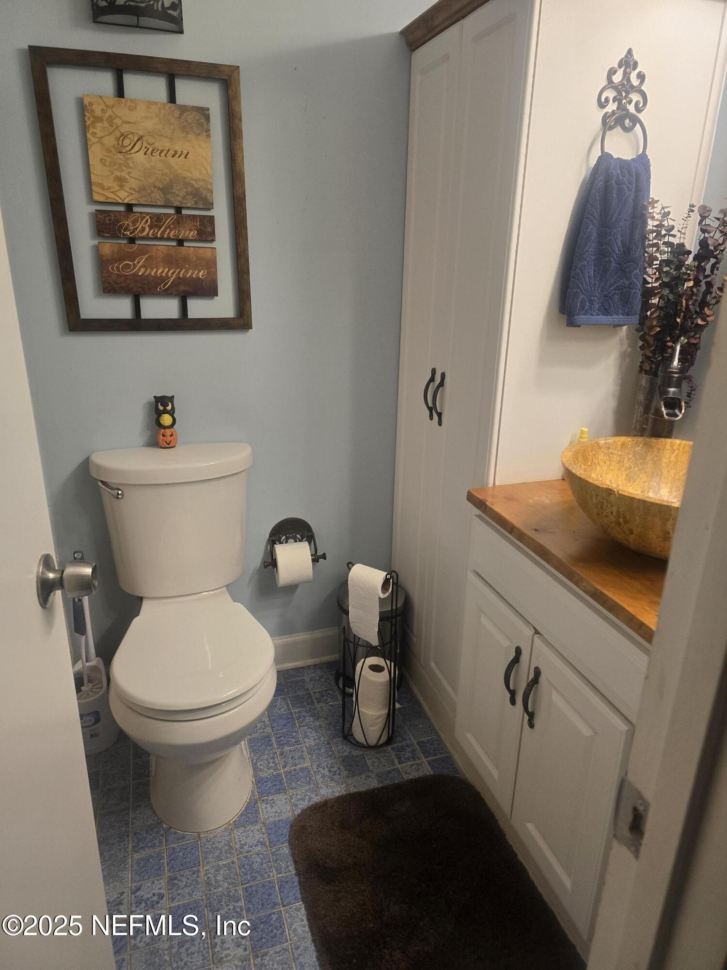 1259 The Grove Road Orange Park, FL 32073 - Photo 7 of 17 a bathroom with a toilet a sink and mirror