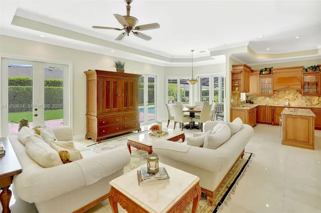 a living room with furniture ceiling fan and a rug
