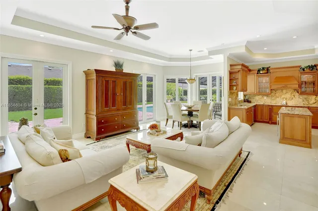 a living room with furniture ceiling fan and a rug