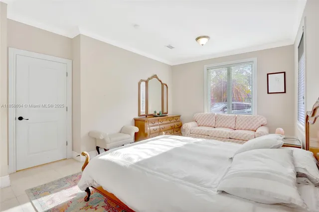 a bedroom with a large bed and a window