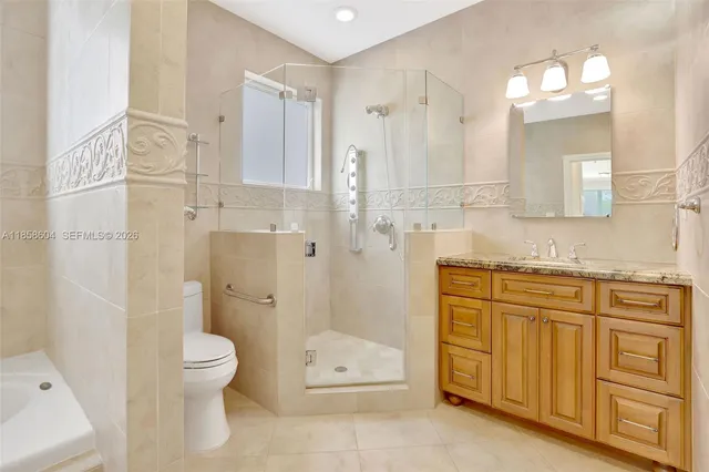 a bathroom with a granite countertop sink toilet and shower