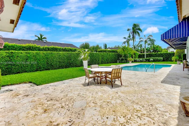 an outdoor view of a garden with sitting area