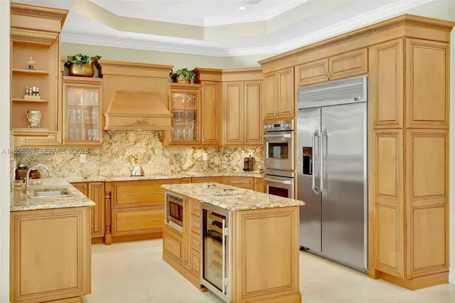 a kitchen with stainless steel appliances granite countertop a refrigerator and a stove
