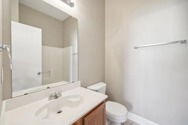 a bathroom with a sink a toilet and a mirror