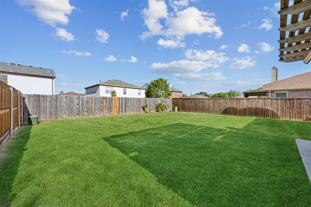 a view of a house with a big yard and large trees