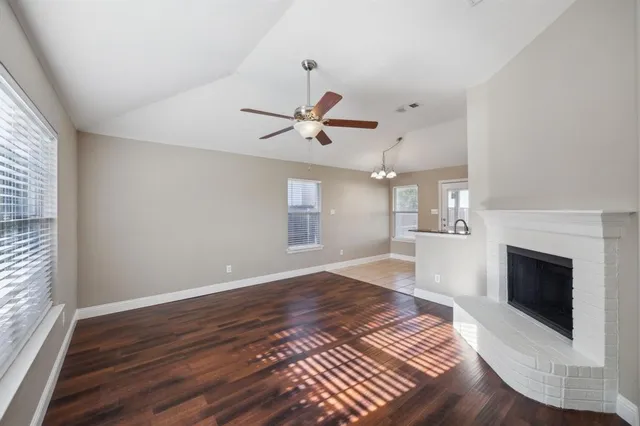 wooden floor in an empty room with a fireplace