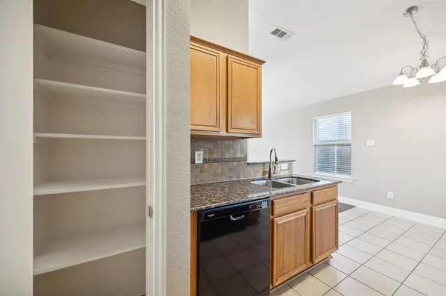 a kitchen with a sink cabinets and window
