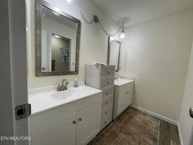 a bathroom with a double vanity sink and mirror