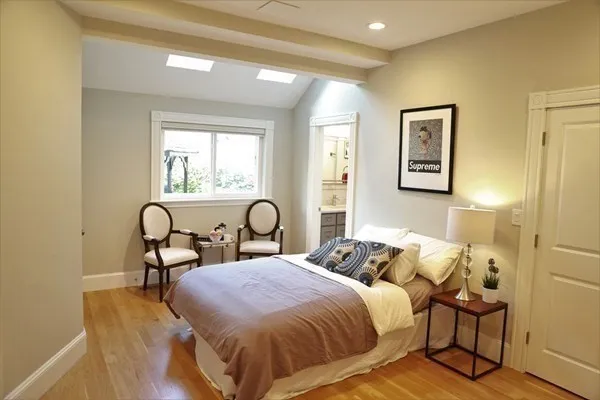 a bedroom with bed and a table with window