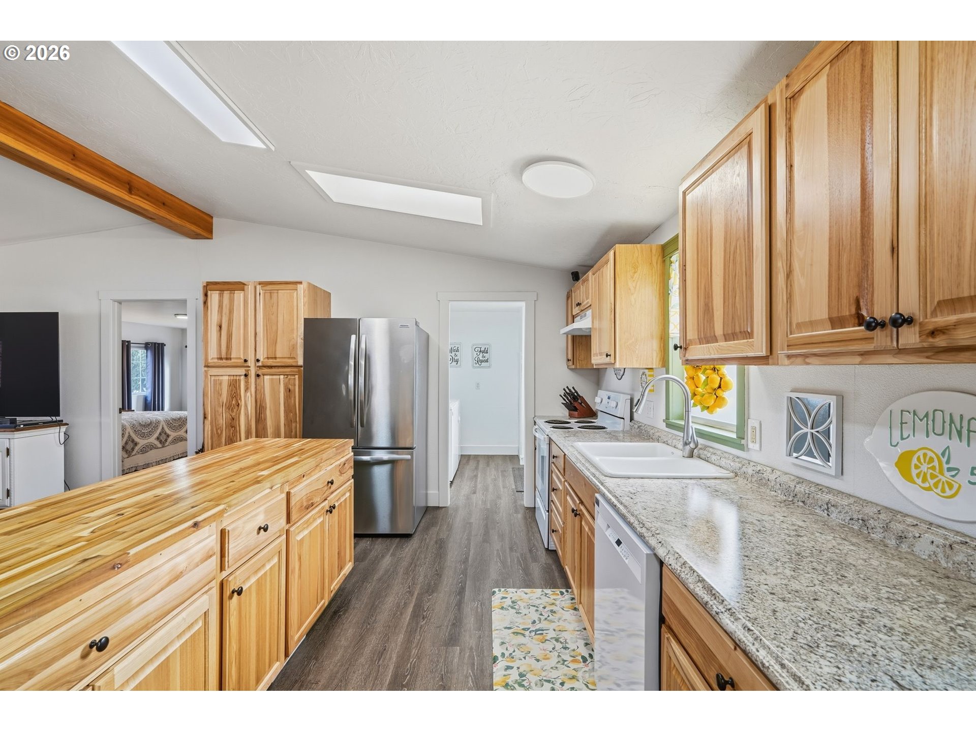 300 Southwest 7th Street, Unit 508 Battle Ground, WA 98604 - Photo 11 of 38 a kitchen with stainless steel appliances granite countertop a sink stove and refrigerator