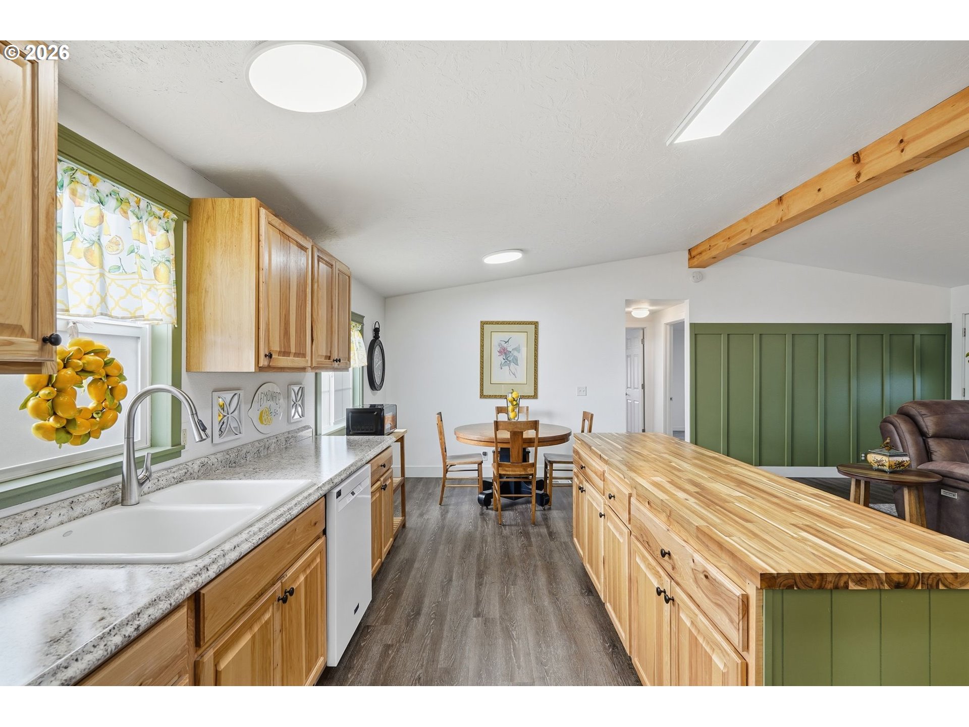 300 Southwest 7th Street, Unit 508 Battle Ground, WA 98604 - Photo 13 of 38 a open kitchen with granite countertop a sink dishwasher a stove and a refrigerator with wooden cabinets