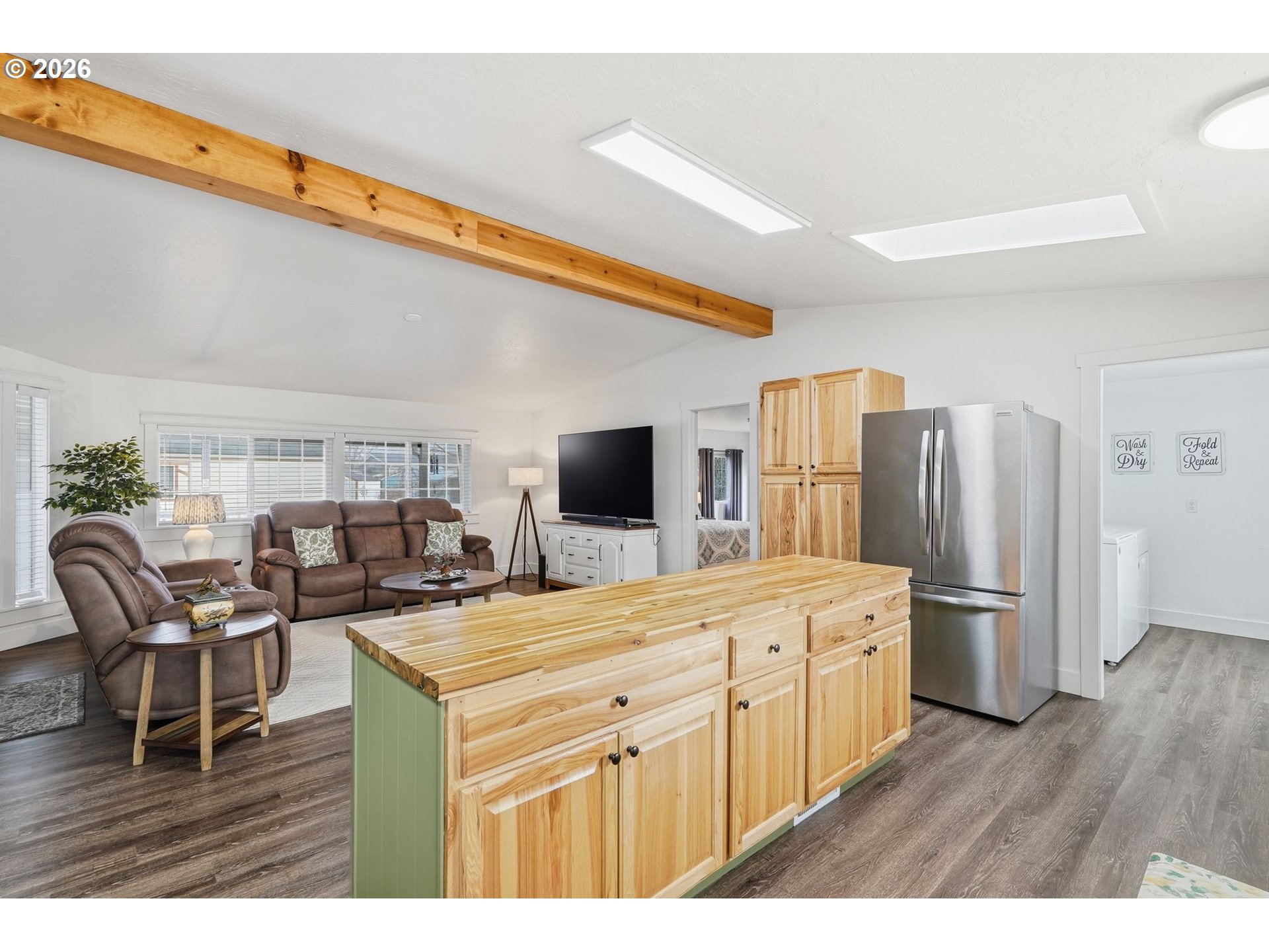 300 Southwest 7th Street, Unit 508 Battle Ground, WA 98604 - Photo 14 of 38 a kitchen with stainless steel appliances kitchen island granite countertop a table chairs and a refrigerator
