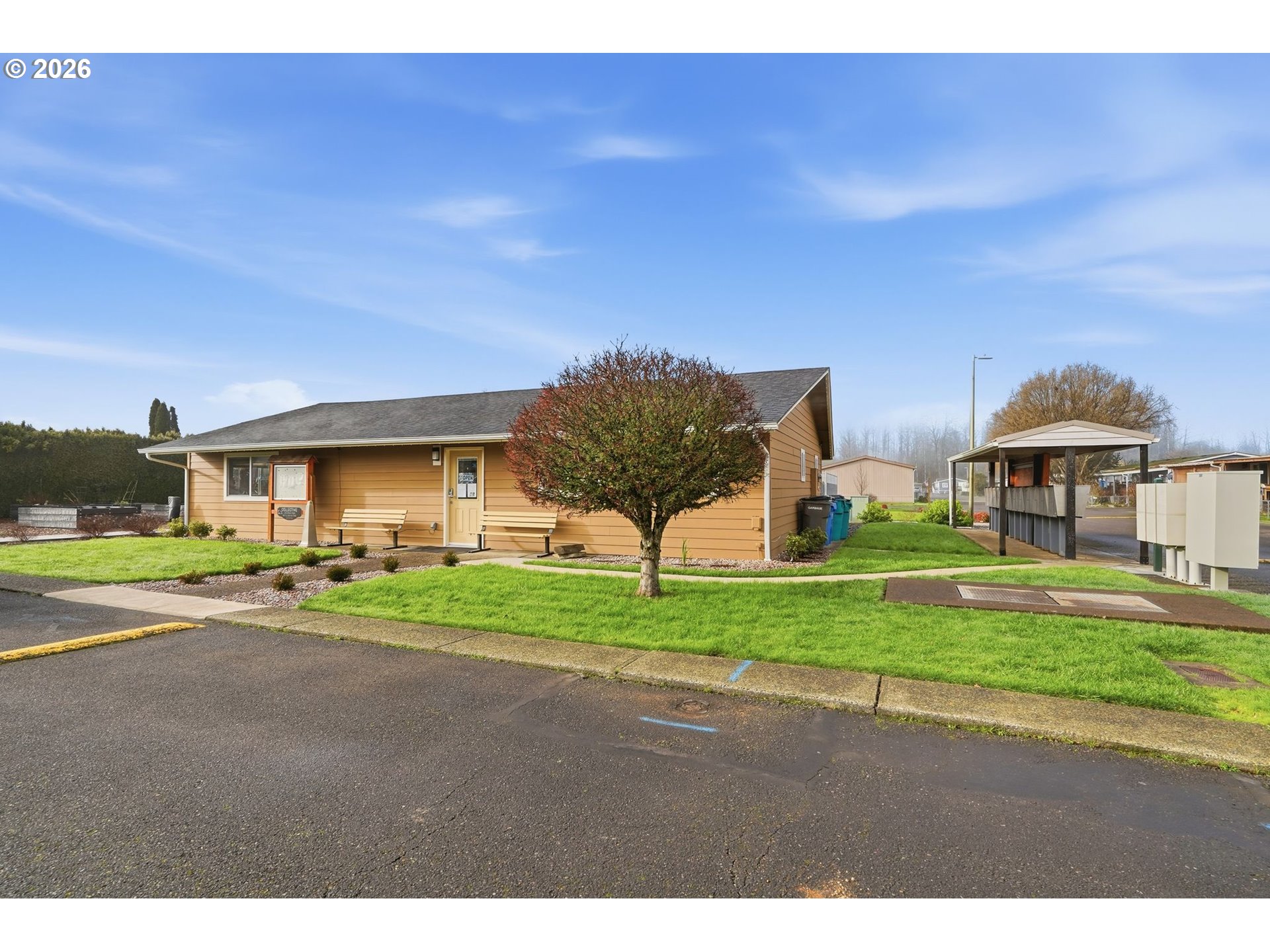 300 Southwest 7th Street, Unit 508 Battle Ground, WA 98604 - Photo 31 of 38 a view of a house with a yard and table and chairs under an umbrella