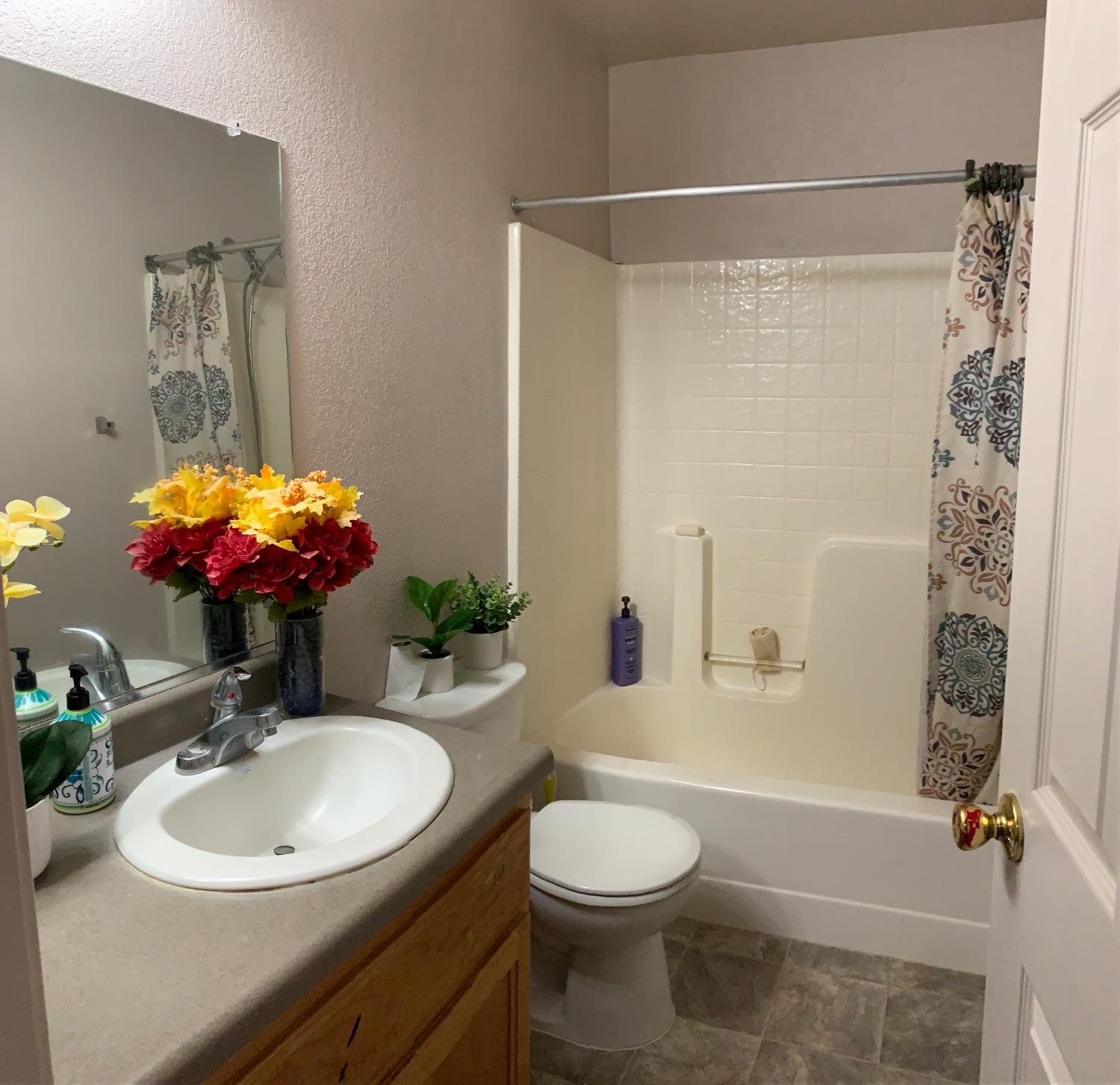 348 Silva Street Mendota, CA 93640 - Photo 17 of 24 a bathroom with a sink a toilet and shower