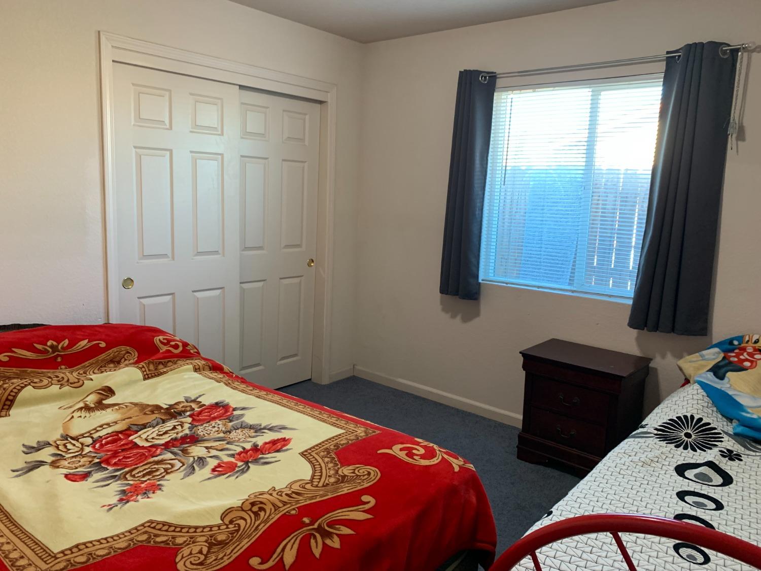 348 Silva Street Mendota, CA 93640 - Photo 20 of 24 a bedroom with a bed and a window