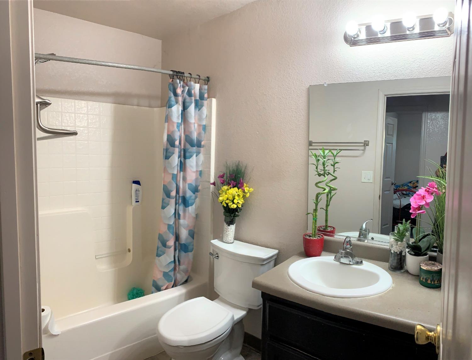 348 Silva Street Mendota, CA 93640 - Photo 21 of 24 a bathroom with a sink toilet and shower