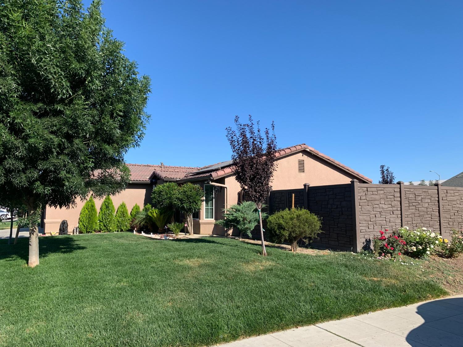 348 Silva Street Mendota, CA 93640 - Photo 4 of 24 a front view of a house with a yard and trees
